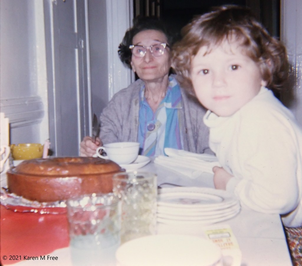 woman and child seated at table with cake