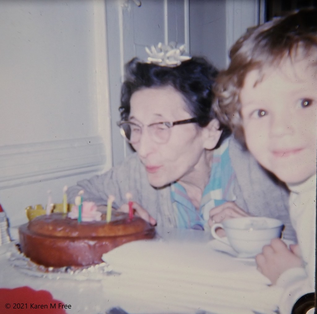 woman blowing out cake candles