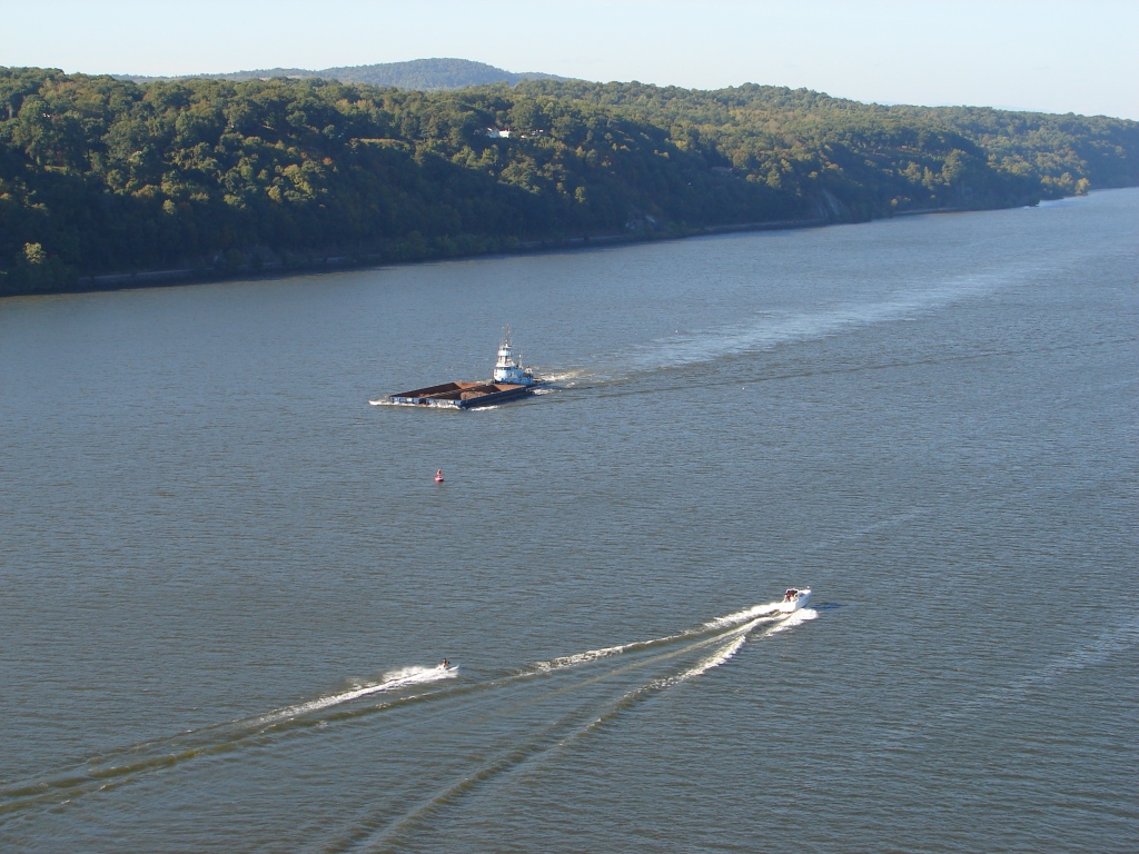 A Jet Ski, a motorboat and a tugboat on the Hudson River