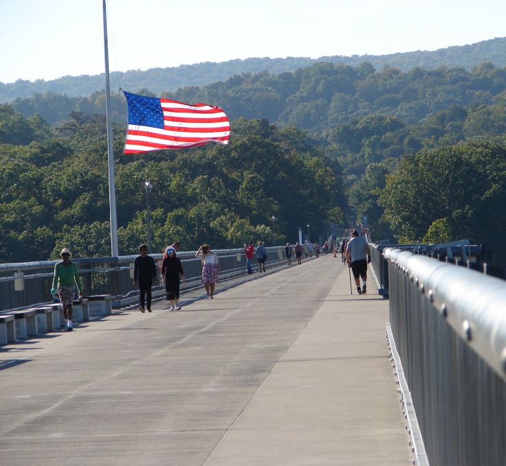 American flag at half-mast on pedestrian bridge