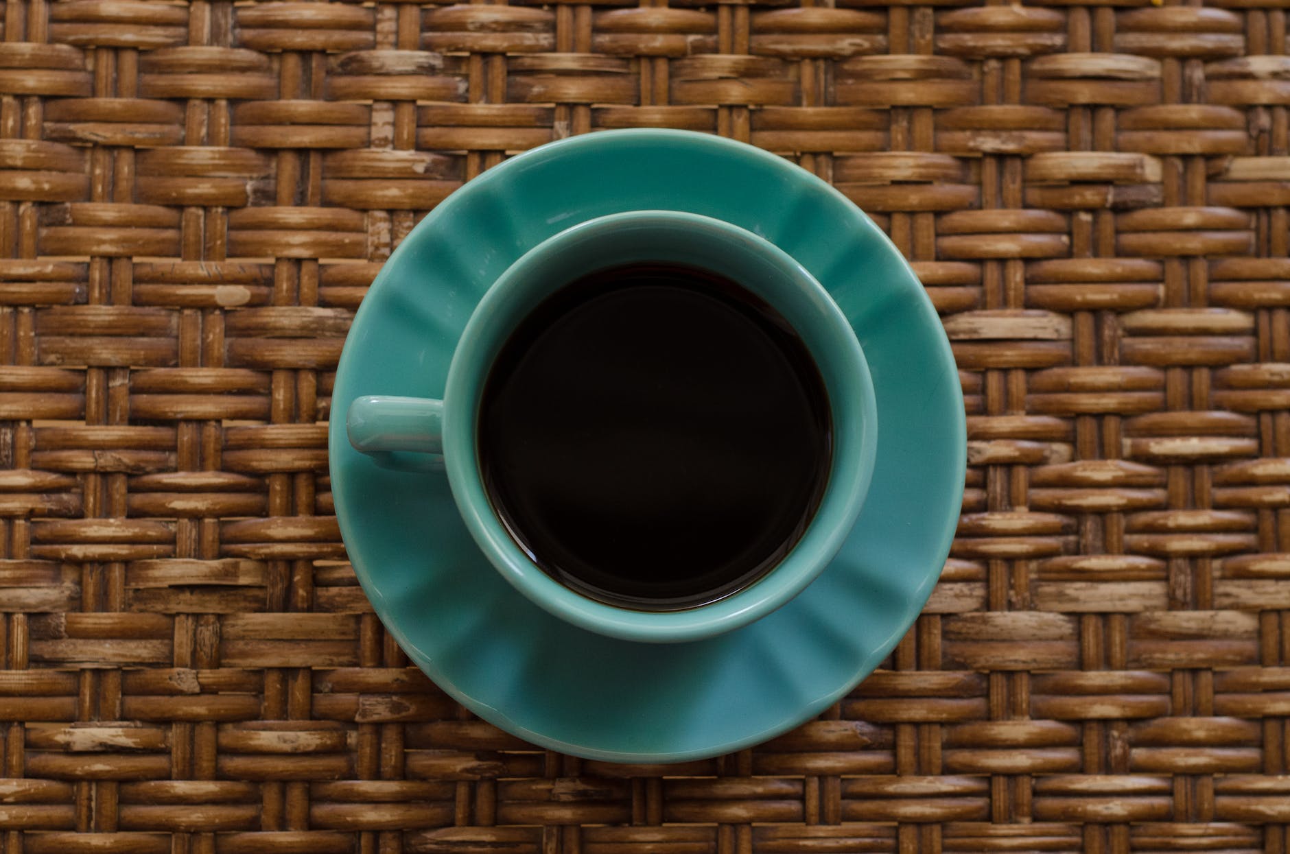 teal ceramic mug on saucer