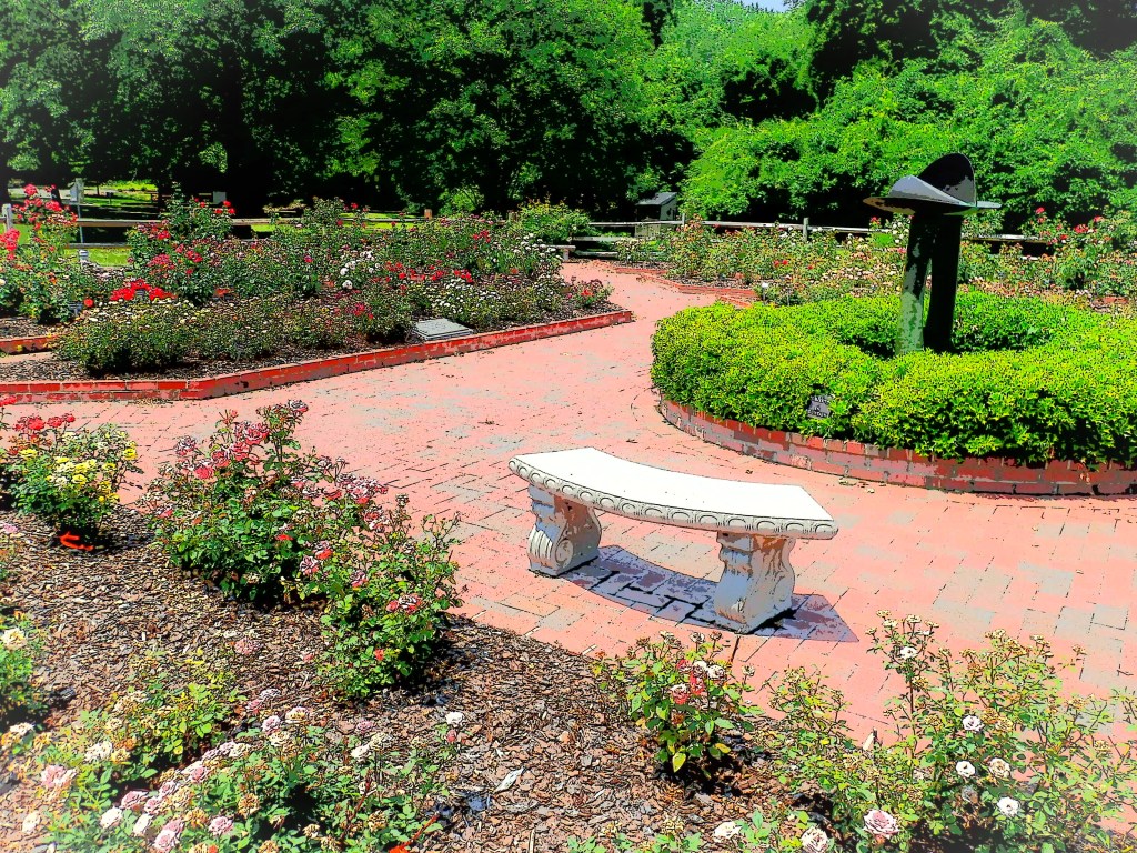 copper sculpture focal point of the garden with concrete bench