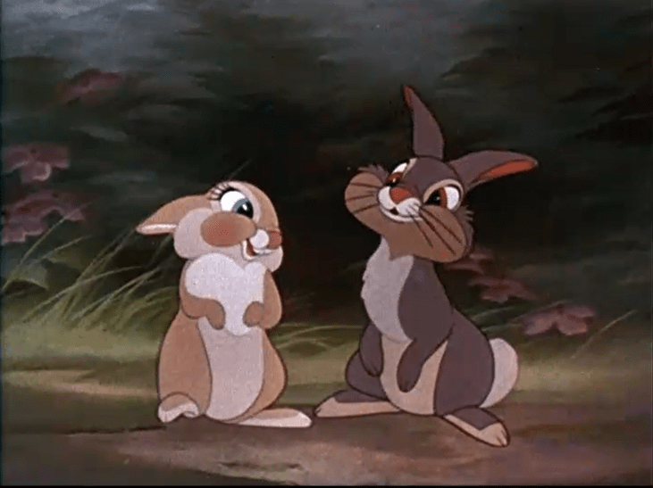 Two animated rabbits sitting up on their back legs.